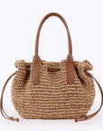 Woven handbag with brown handles on a white background