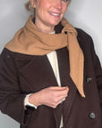 woman wearing a brown jacket and a camel wool scarf