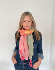 Woman wearing a colorful striped scarf and a denim outfit