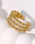 A gold-colored dotted adjustable ring made from gold-plated stainless steel