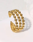 A gold-colored dotted adjustable ring made from gold-plated stainless steel