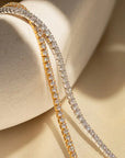 a close-up of a gold and silver tennis bracelet.
