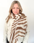 Woman wearing a brown and cream zebra print lightweight scarf