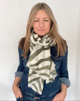 Woman wearing a khaki and white zebra print striped scarf