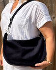 woman wearing a navy shoulder bag