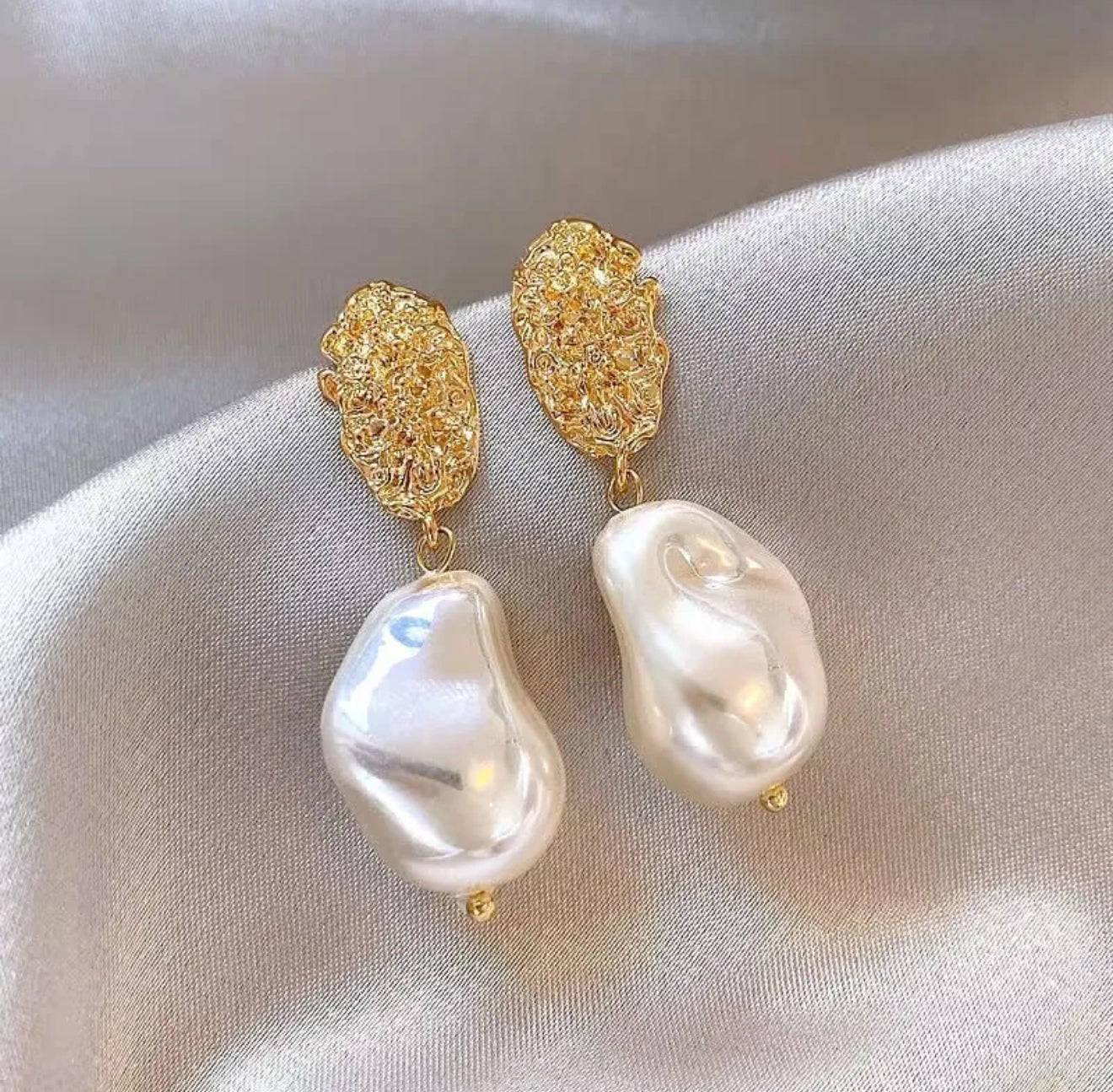 Pearl drop and gold earrings. 