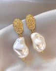 Pearl drop and gold earrings. 