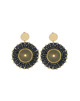Pair of earrings with black and gold circular design on a white background