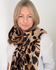 Woman wearing a brown leopard print scarf in midweight