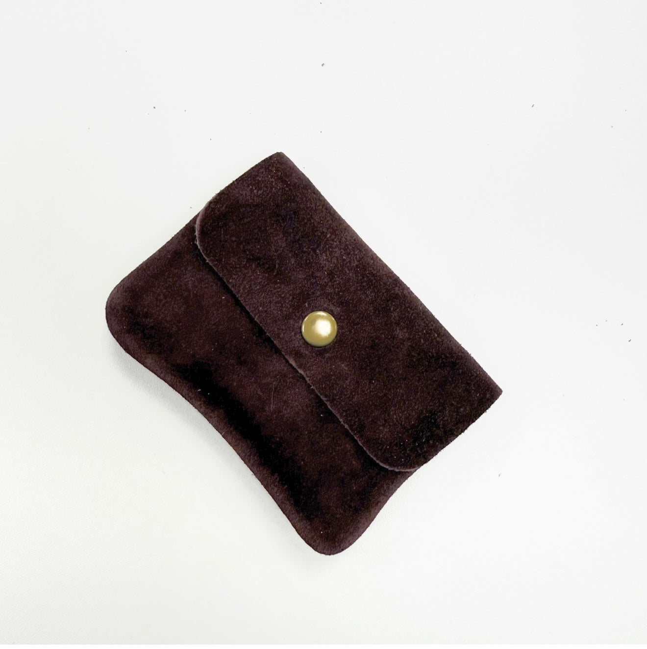 Burgundy suede wallet with a gold button. 