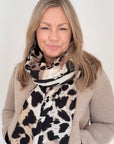 Woman wearing an autumn winter taupe leopard & zebra print blanket scarf 