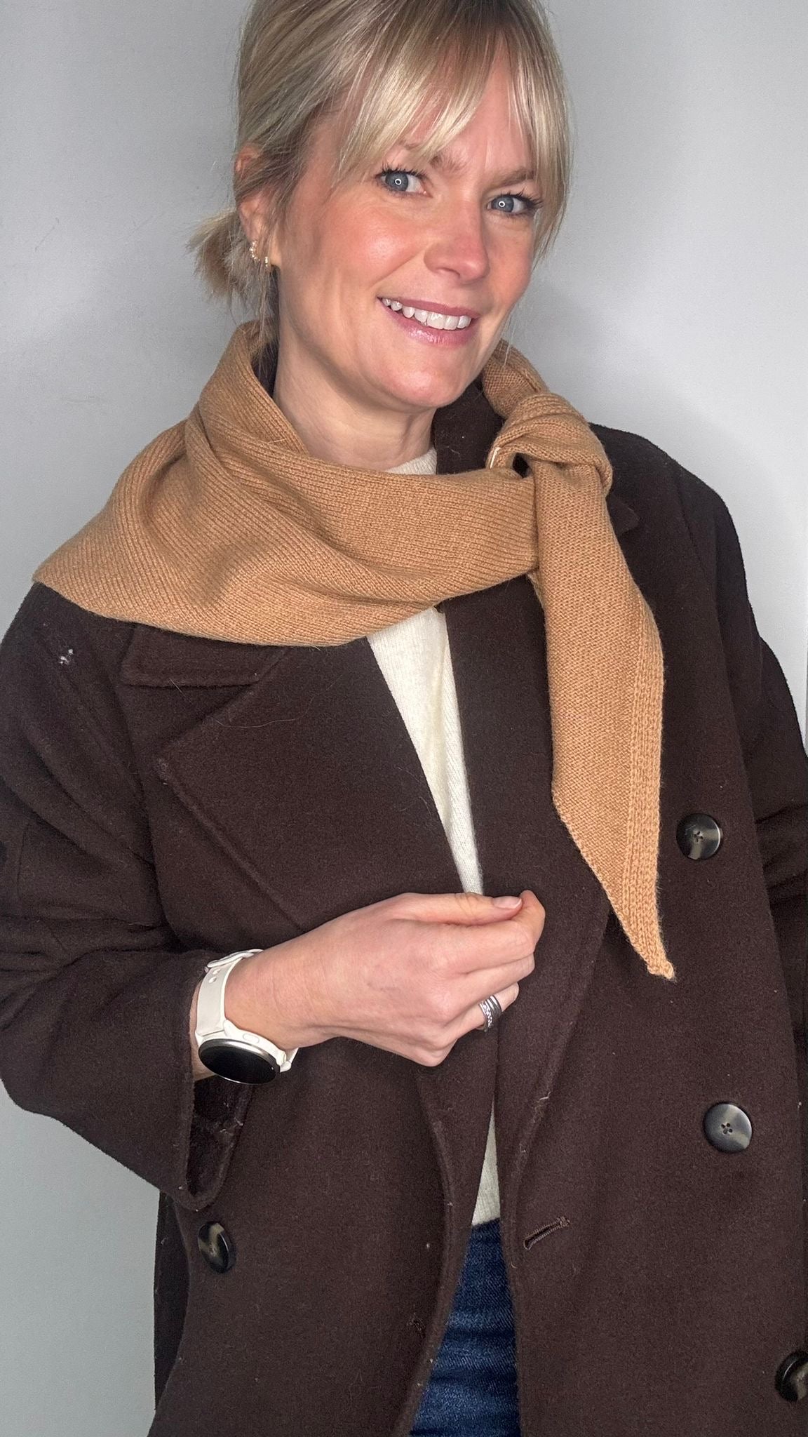 woman wearing a brown jacket and a camel wool scarf