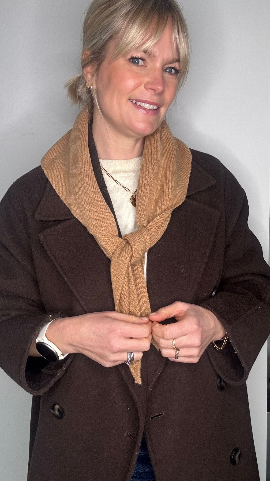 woman wearing a brown jacket and a camel wool scarf