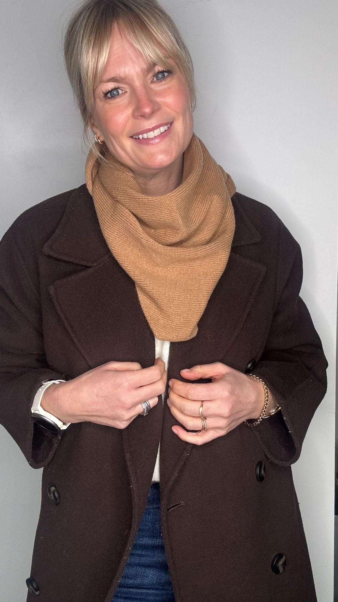 woman wearing a brown jacket and a camel wool scarf