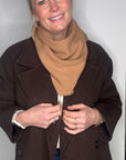 woman wearing a brown jacket and a camel wool scarf