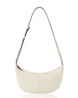 Cream crossbody handbag with a wide strap on a white background.