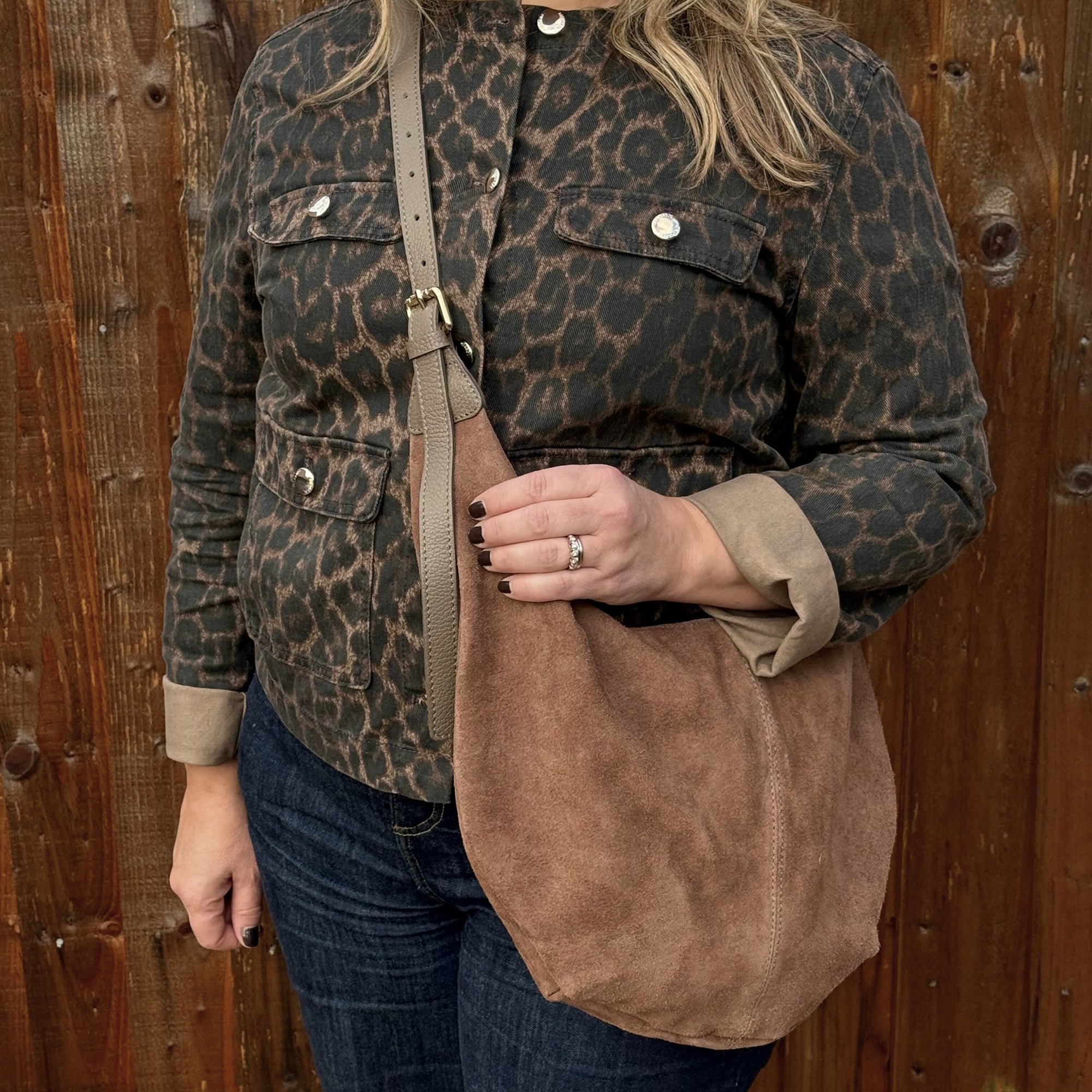 woman wearing a leopard print jacket holding a Dark taupe suede XL crossbody swing  bag 