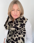 Woman wearing a khaki leopard print scarf for autumn winter