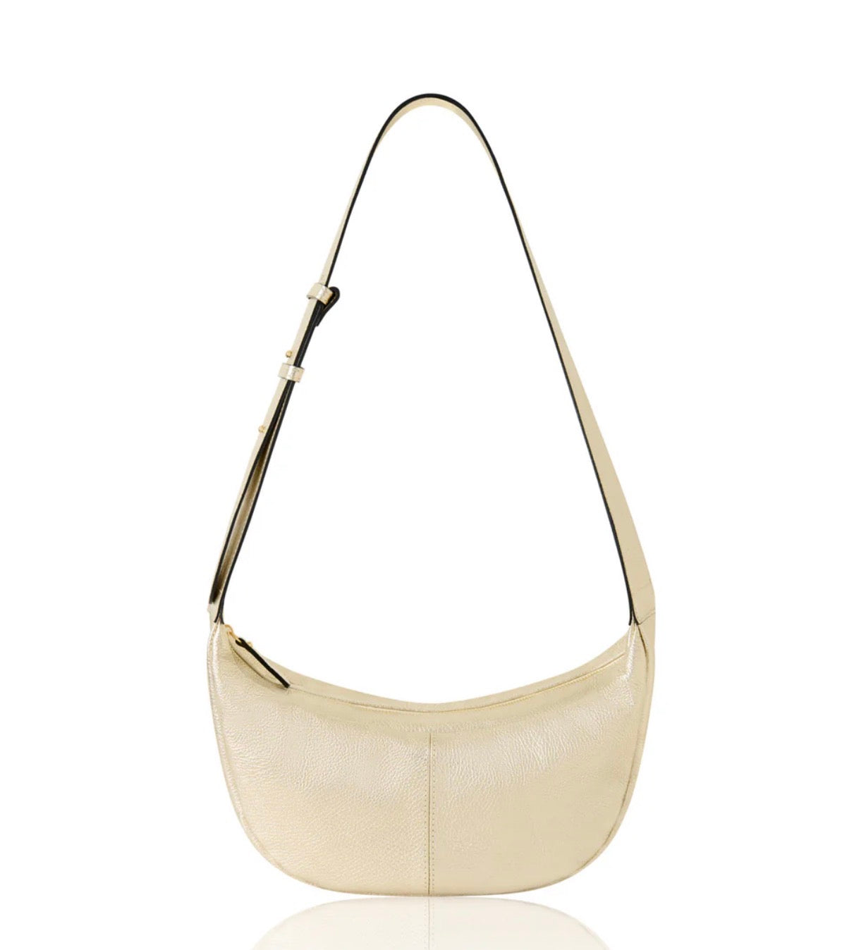 Gold crossbody handbag with a strap on a white background.
