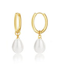 Gold hoop earrings with white teardrop-shaped pearls on a white background