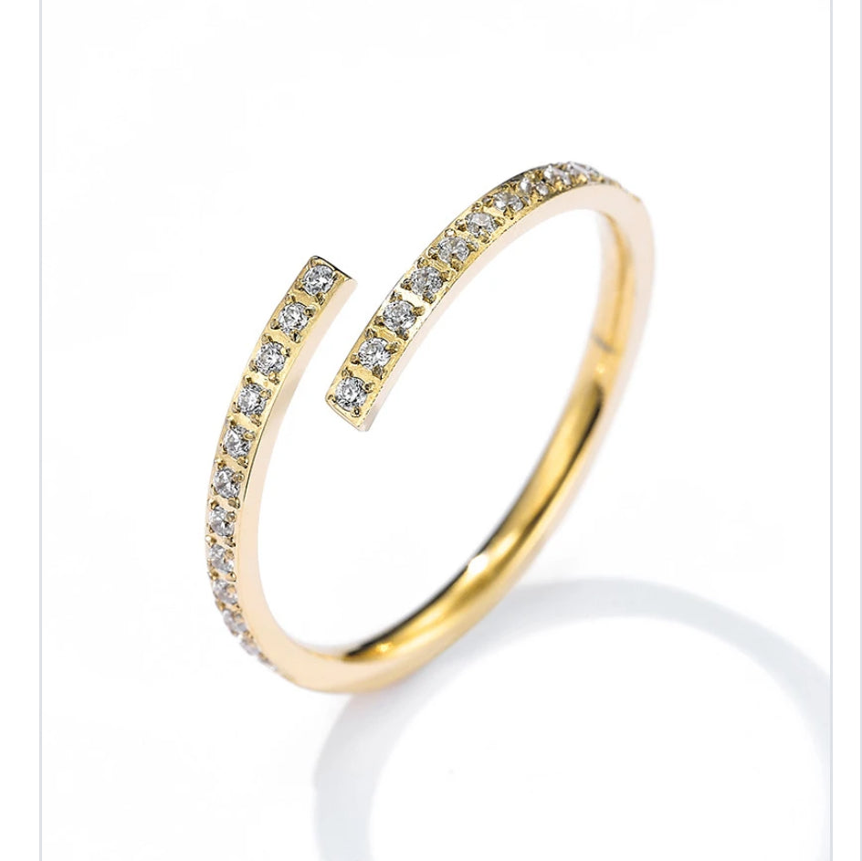 Gold adjustable ring with diamond accents on a white background