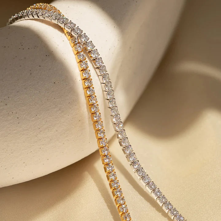 a close-up of a gold and silver tennis bracelet. 