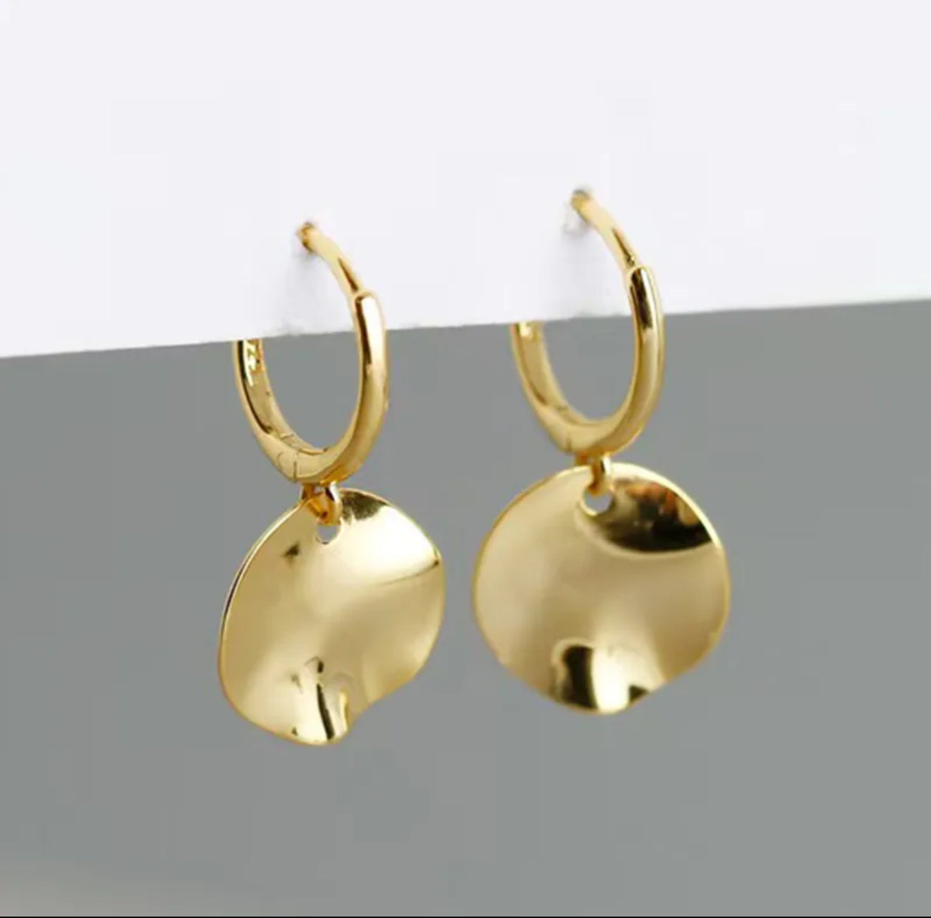 Gold hoop earrings with textured disc pendants