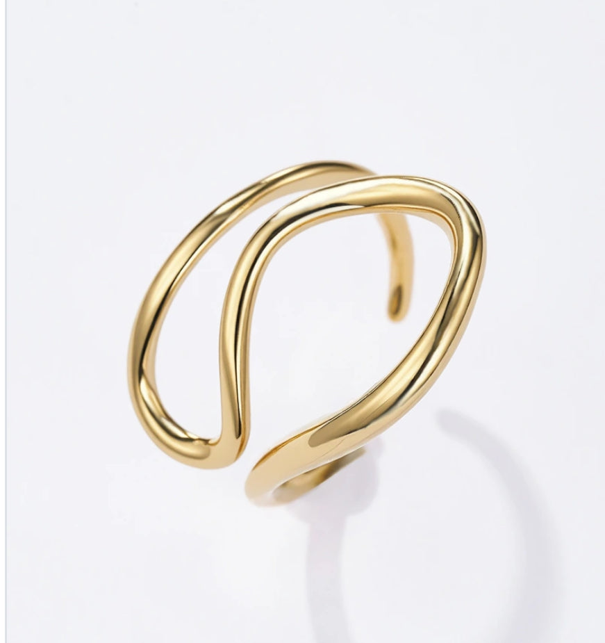 Gold twist design adjustable ring with a modern design on a white background