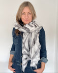 woman  wearing a grey and white animal print  patterned scarf 