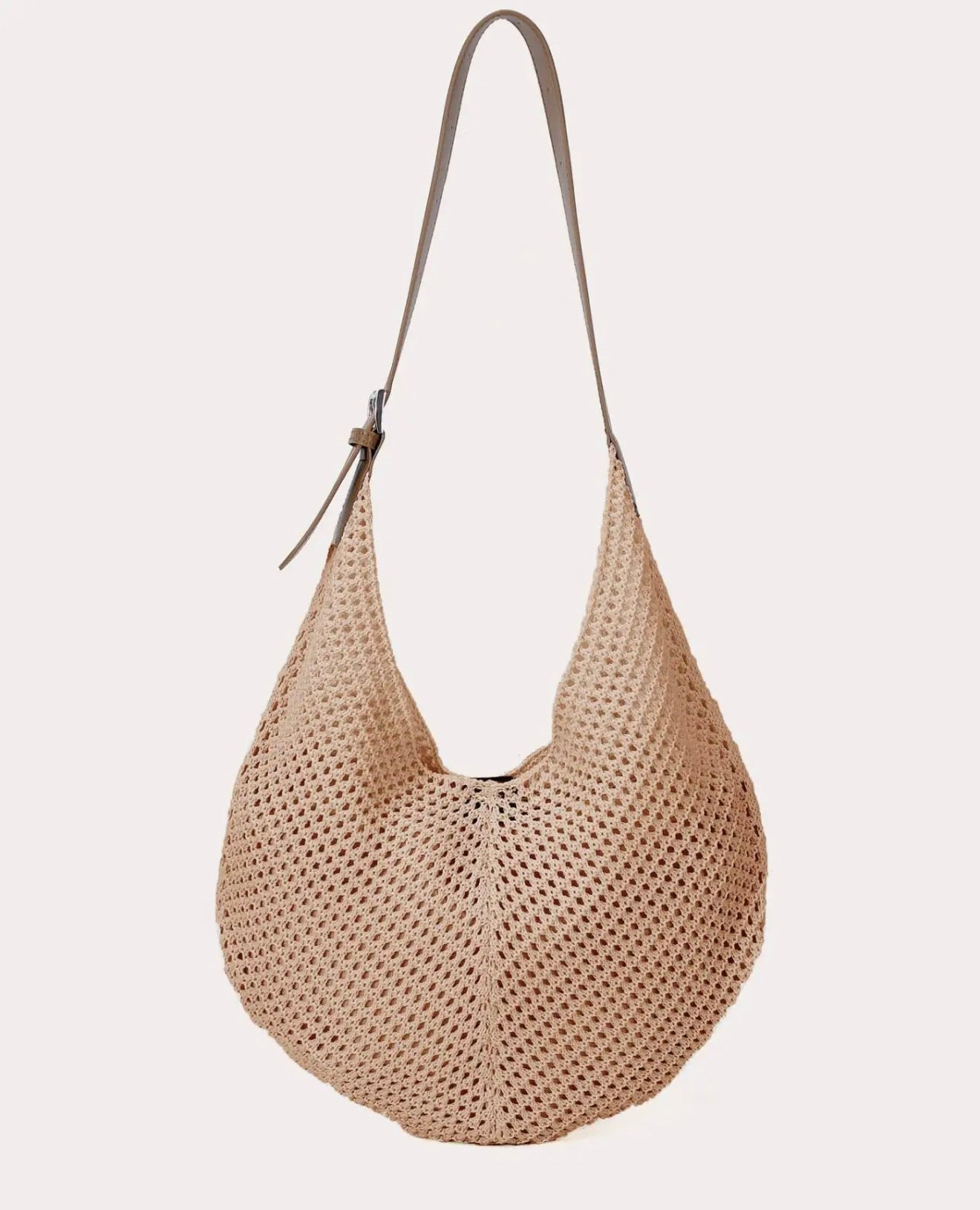 natural woven handbag with a strap on a white background