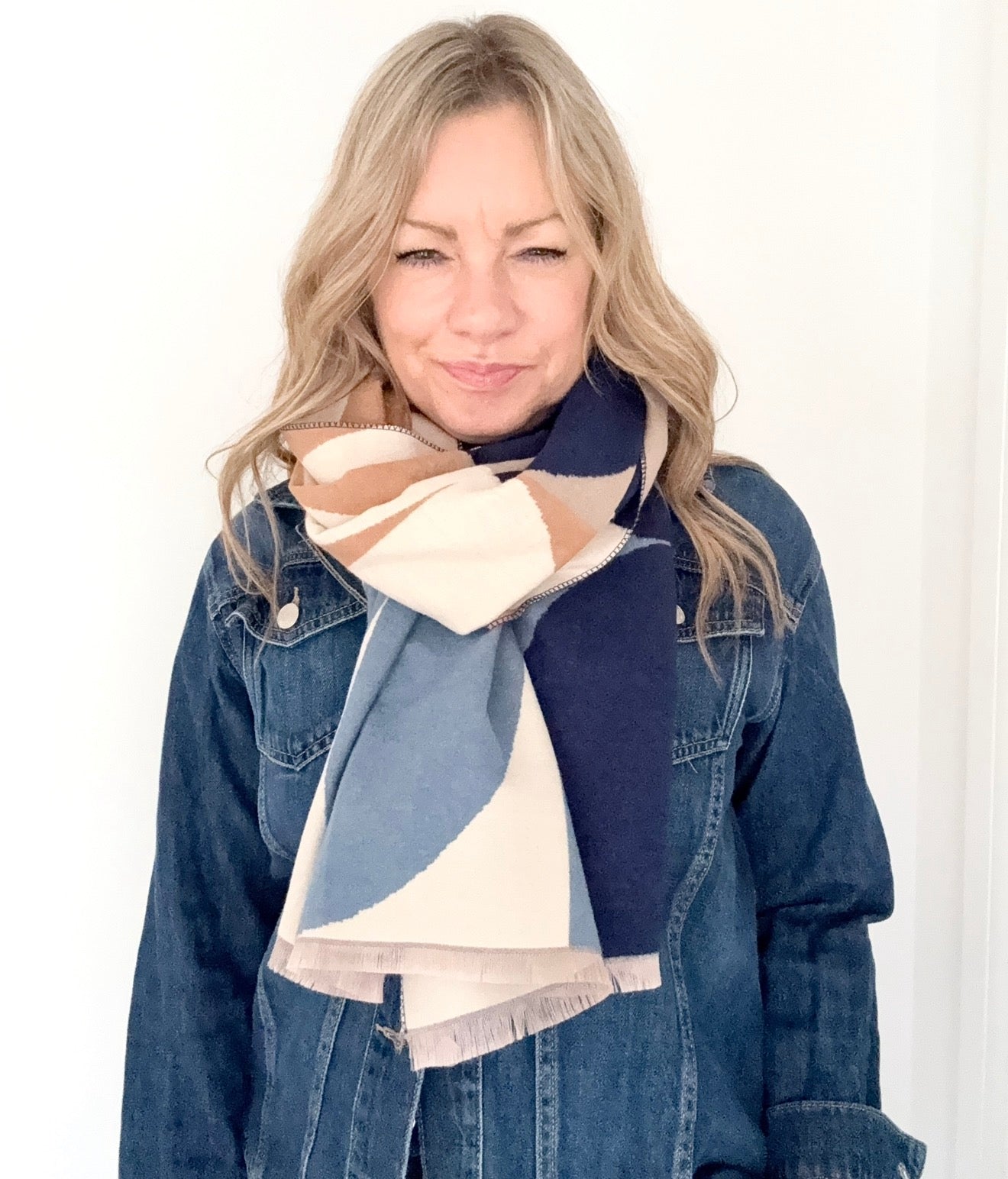 woman wearing a navy and cream retro print scarf with a navy denim jacket 