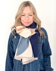 woman wearing a navy and cream retro print scarf with a navy denim jacket 