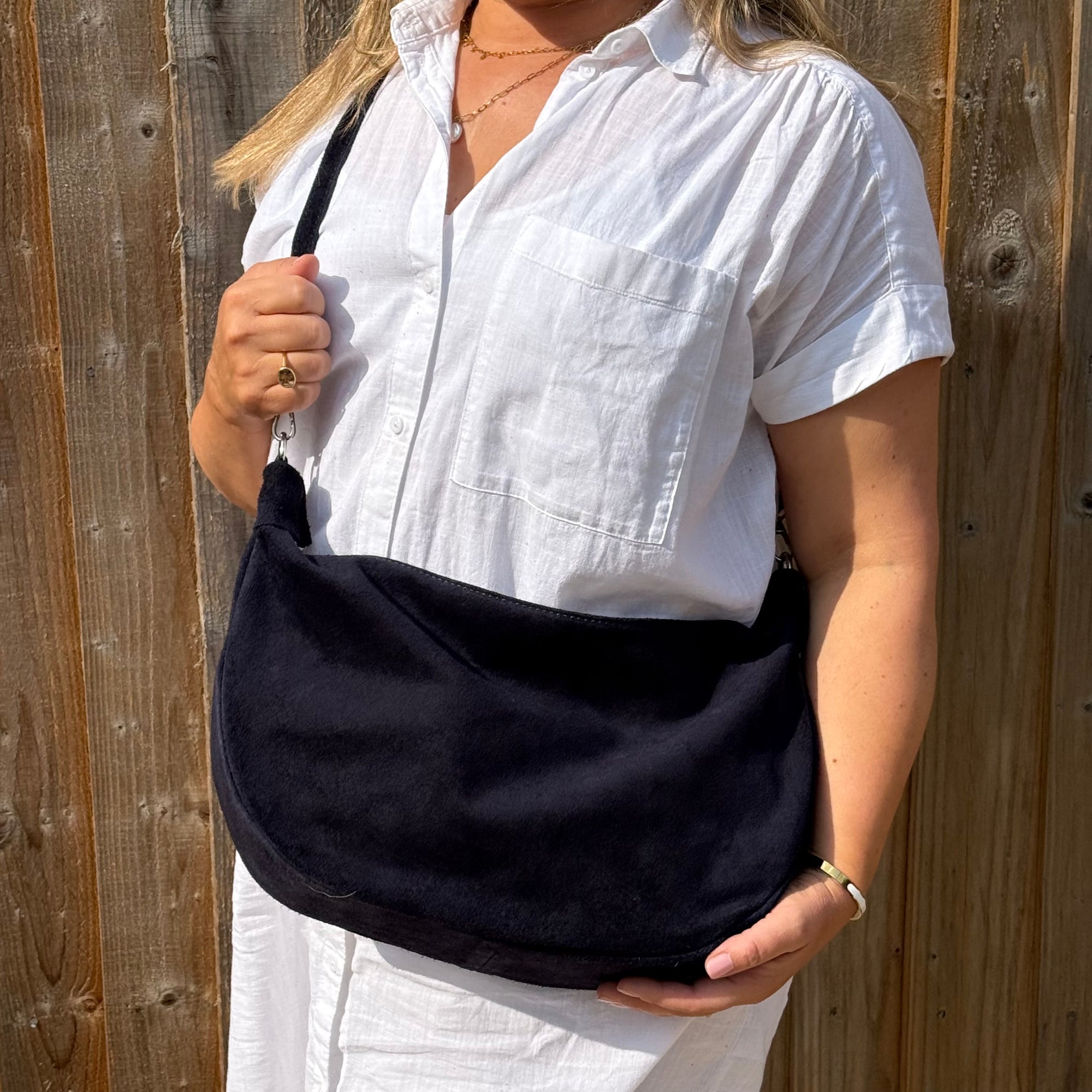 woman holding a navy bag 