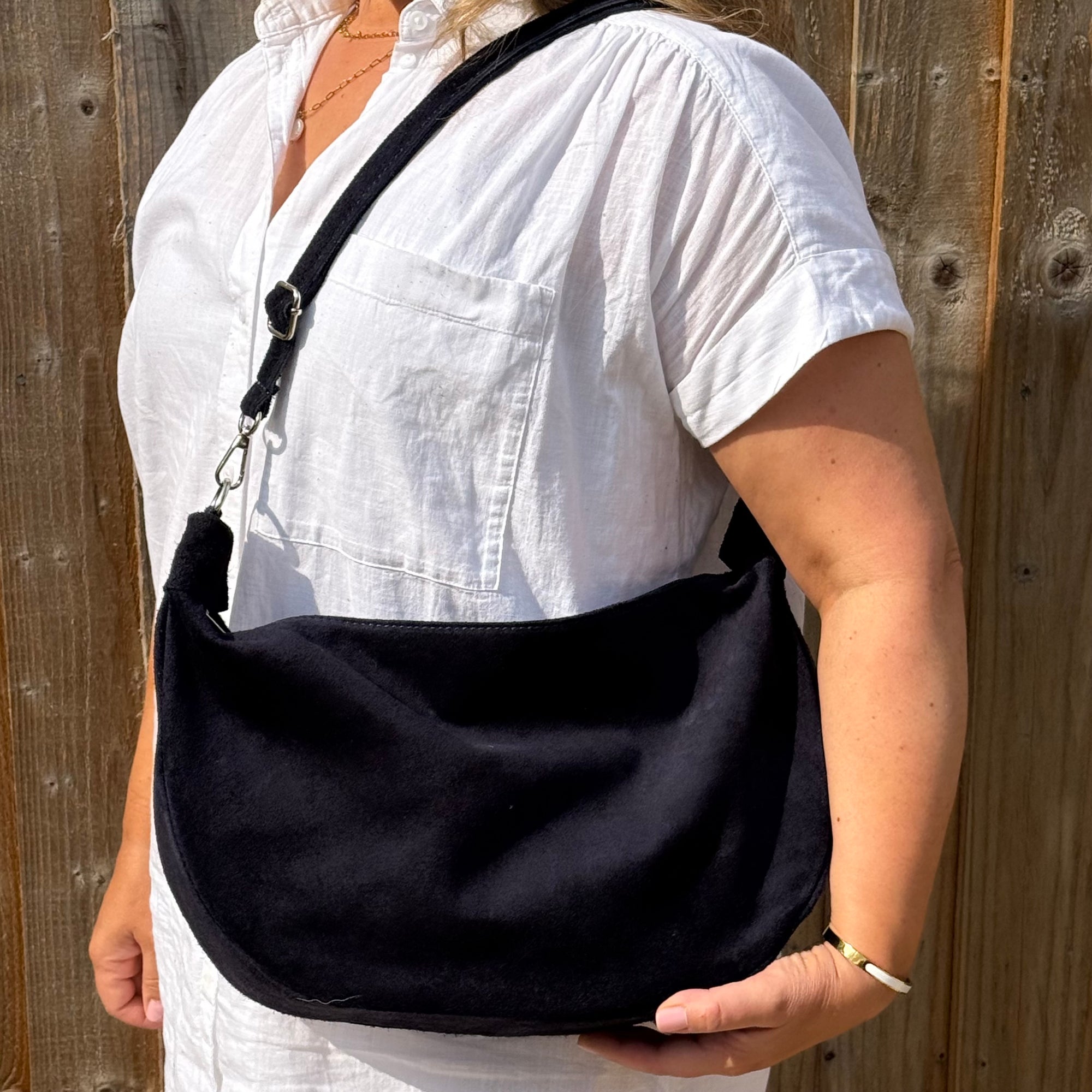 woman wearing a navy shoulder bag 