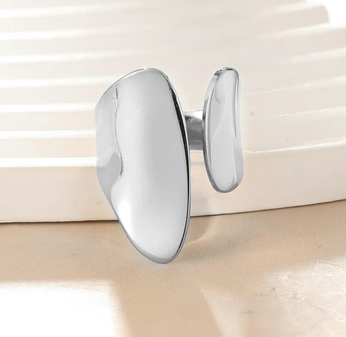silver chunky adjustable ring on a white stand 