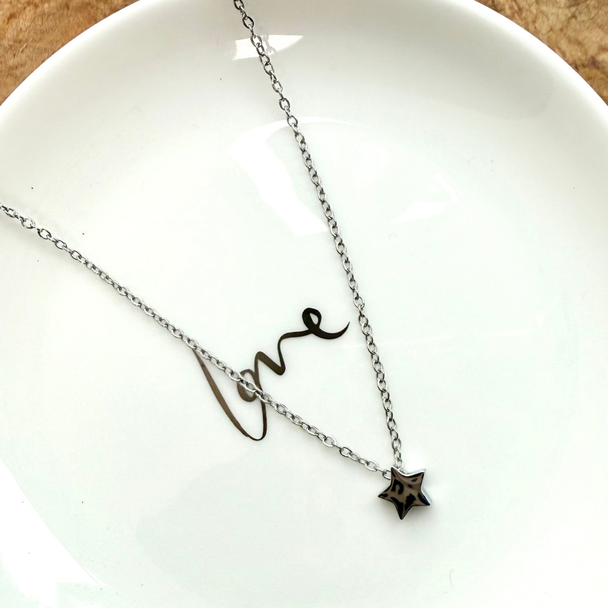 Silver necklace  on a white dish