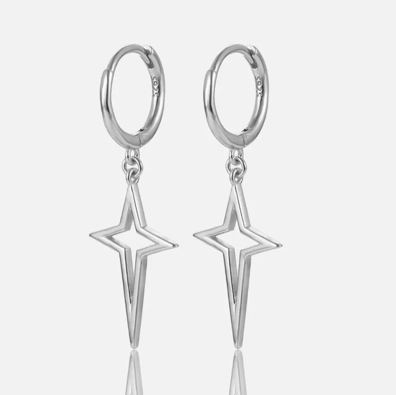 Silver long star hoop earrings with star-shaped pendants on a white background