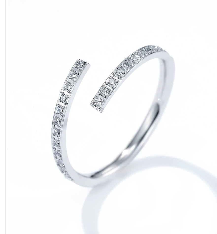 Silver open adjustable  ring with small diamonds on a white background