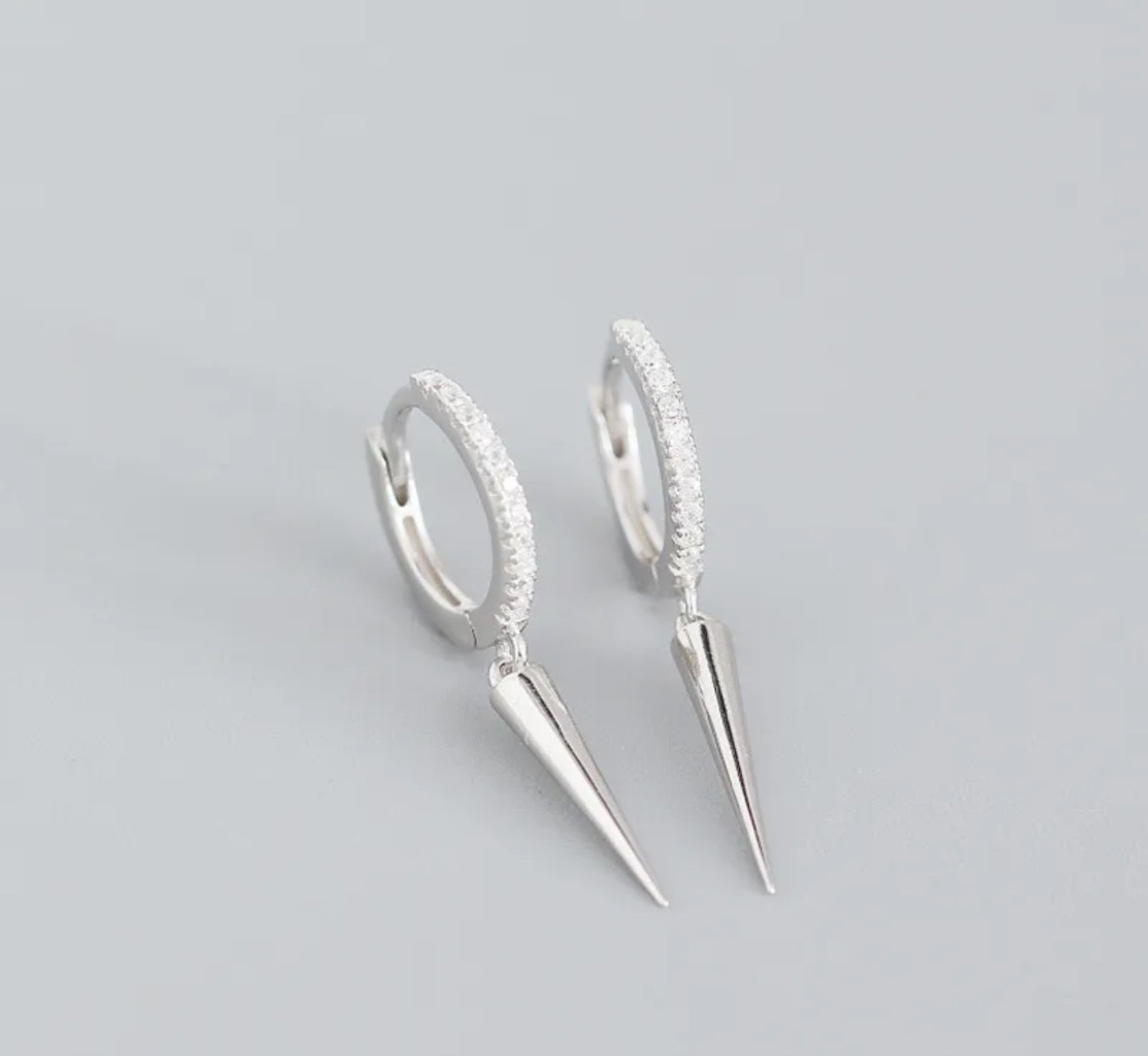 Silver hoop earrings with spike designs 