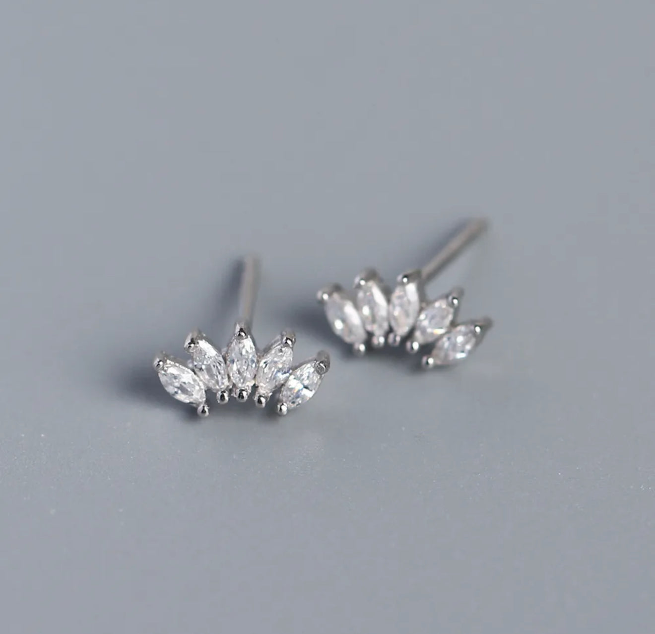 Pair of silver  sparkle stud earrings with clear gemstones. 
