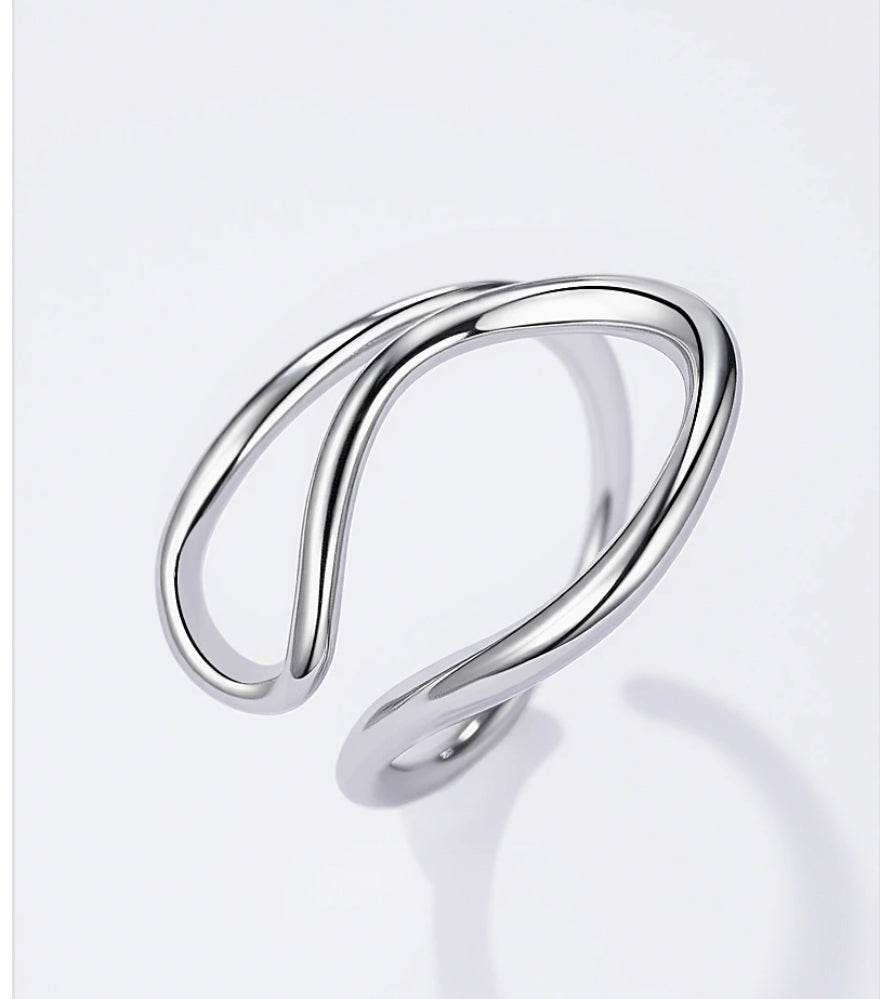 Silver twist design open adjustable ring on a light grey background