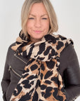 Woman wearing a tan leopard & zebra print blanket scarf for autumn winter