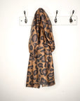  mixed animal print scarf draped over a peg on a white wall