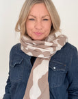 Woman wearing a taupe & ecru animal print scarf for Autumn Winter