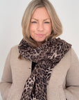 Woman wearing a midweight taupe mix leopard print scarf for autum,n winter layering